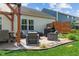 Inviting back patio featuring an outdoor kitchen, comfortable seating and charming pergola for stylish outdoor living at 3420 Stoddard Pl, Indianapolis, IN 46217