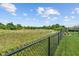 Serene backyard view showcasing a secure fenced yard overlooking lush greenery and beautiful nature at 3420 Stoddard Pl, Indianapolis, IN 46217