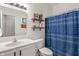 Bathroom vanity, toilet, shelves, mirror and patterned shower curtain featuring modern fixtures at 3420 Stoddard Pl, Indianapolis, IN 46217