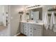 Well-lit bathroom with a double vanity, sleek mirrors, and stylish fixtures at 3420 Stoddard Pl, Indianapolis, IN 46217