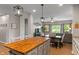 Open kitchen flows into the living area, featuring a butcher block island with pendant lighting at 3420 Stoddard Pl, Indianapolis, IN 46217