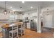 Modern kitchen featuring stainless steel appliances, wooden island with seating, and seamless integration into the living space at 3420 Stoddard Pl, Indianapolis, IN 46217