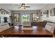 Comfortable living room with a ceiling fan, large windows, and view of the backyard at 3420 Stoddard Pl, Indianapolis, IN 46217