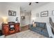 Cozy living room featuring a gray sofa, hardwood floors, modern lighting, and view into a well-organized entryway at 3420 Stoddard Pl, Indianapolis, IN 46217
