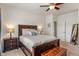 Spacious primary bedroom featuring dark wood furniture, a neutral color palette, and soft lighting at 3420 Stoddard Pl, Indianapolis, IN 46217