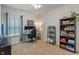 Functional home office with desk, dual monitors, shelving, bookcase, and natural light from a window at 3420 Stoddard Pl, Indianapolis, IN 46217