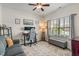 Functional office space, featuring a comfortable couch, large window, gaming chair, and a neat and neutral decor at 3420 Stoddard Pl, Indianapolis, IN 46217