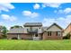 Two-story brick home with a lush green yard and upper-level deck at 369 Rodeo Dr, Indianapolis, IN 46217