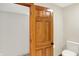 Neutral bathroom with wooden door, white toilet, and tan walls at 369 Rodeo Dr, Indianapolis, IN 46217