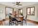 Bright dining room with a round table, seating for six, and views into the living room and backyard at 369 Rodeo Dr, Indianapolis, IN 46217
