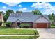 Beautiful brick home featuring an attached garage, mature landscaping, and a well-manicured lawn at 369 Rodeo Dr, Indianapolis, IN 46217