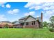 Two-story brick home with an upper-level deck on a manicured lawn at 369 Rodeo Dr, Indianapolis, IN 46217
