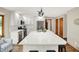 Spacious kitchen with a large island, white cabinets, stainless steel appliances, and modern lighting fixtures at 369 Rodeo Dr, Indianapolis, IN 46217