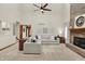 Open-concept living area with a fireplace, modern furnishings, and abundant natural light at 369 Rodeo Dr, Indianapolis, IN 46217