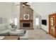 Inviting living room with a soaring ceiling, large brick fireplace, and comfortable seating at 369 Rodeo Dr, Indianapolis, IN 46217