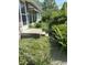 Close-up of a concrete front porch with shrubbery around a stone and siding home at 3709 N Layman Ave, Indianapolis, IN 46218