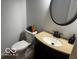 Bathroom featuring a modern toilet and granite topped vanity with oval mirror at 3815 Briar Rdg, Monrovia, IN 46157