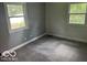 Empty bedroom with grey carpet, walls and two windows for an abundance of natural light at 3815 Briar Rdg, Monrovia, IN 46157
