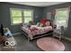 Cozy bedroom featuring a white iron bed frame and two windows for plenty of natural light at 3815 Briar Rdg, Monrovia, IN 46157