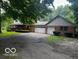 Inviting brick home featuring a large porch, mature trees, and an ample driveway at 3815 Briar Rdg, Monrovia, IN 46157