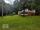 Scenic view of a two-story home with lush green lawn and surrounding trees at 3815 Briar Rdg, Monrovia, IN 46157