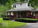 Inviting two-story home featuring a charming covered front porch with American flag at 3815 Briar Rdg, Monrovia, IN 46157