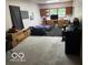 Spacious garage with large door, concrete flooring, TV, and storage cabinets at 3815 Briar Rdg, Monrovia, IN 46157
