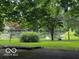 Scenic view of a serene pond framed by mature trees and lush landscaping at 3815 Briar Rdg, Monrovia, IN 46157