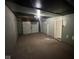 Unfinished basement offering potential for customization, including a garage door and doorway at 4405 Phoenix Dr, Indianapolis, IN 46241
