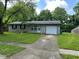 Charming single-story home with stone accents, an attached garage, and a well-maintained lawn at 4405 Phoenix Dr, Indianapolis, IN 46241