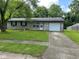 Charming single-story home with stone accents, an attached garage, and a well-maintained lawn at 4405 Phoenix Dr, Indianapolis, IN 46241