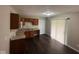 Functional kitchen with brown cabinetry, modern appliances, and hardwood floors, leading to the backyard at 4405 Phoenix Dr, Indianapolis, IN 46241
