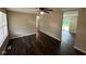 An inviting living room with hardwood floors, ceiling fan, and access to the backyard at 4405 Phoenix Dr, Indianapolis, IN 46241