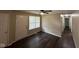 Spacious living room with hardwood floors, a ceiling fan, and ample natural light from a large window at 4405 Phoenix Dr, Indianapolis, IN 46241