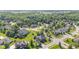 A captivating aerial view displays a community with sprawling lots and homes nestled amongst lush trees at 4465 W Woodbridge Ln, New Palestine, IN 46163