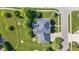 Bird's eye view of house with manicured lawn and mature landscaping, highlighting roof detail at 4465 W Woodbridge Ln, New Palestine, IN 46163