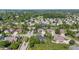 Aerial of neighborhood featuring a pond, mature trees, and well-maintained residential properties at 4465 W Woodbridge Ln, New Palestine, IN 46163