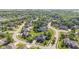 An aerial view captures the serene neighborhood with mature trees and diverse home styles at 4465 W Woodbridge Ln, New Palestine, IN 46163