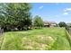 Large backyard featuring a manicured lawn, mature trees, and ample space for recreation at 4465 W Woodbridge Ln, New Palestine, IN 46163
