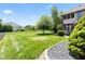 Lush green backyard with well-maintained lawn and view of neighborhood homes at 4465 W Woodbridge Ln, New Palestine, IN 46163
