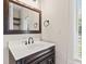 A vanity with a faucet, a mirror, and a window with natural light at 4465 W Woodbridge Ln, New Palestine, IN 46163