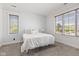 Well-lit bedroom featuring neutral carpet, large windows, and simple decor at 4465 W Woodbridge Ln, New Palestine, IN 46163