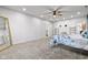 Bright bedroom with neutral carpet, ceiling fan, and lots of space at 4465 W Woodbridge Ln, New Palestine, IN 46163