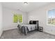 Bright bedroom with natural light, neutral carpet, and minimalist decor at 4465 W Woodbridge Ln, New Palestine, IN 46163