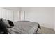 Carpeted bedroom featuring a bed with pillows and access to attached bathroom and closet at 4465 W Woodbridge Ln, New Palestine, IN 46163