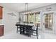 Bright dining area with large window overlooking the backyard and hanging light fixture at 4465 W Woodbridge Ln, New Palestine, IN 46163
