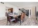 Elegant dining room features a wood table, seating for six, and stylish flooring at 4465 W Woodbridge Ln, New Palestine, IN 46163