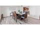 Contemporary dining room set with a view of a doorway to another room at 4465 W Woodbridge Ln, New Palestine, IN 46163