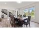 Bright dining room with large window, wood table, and staircase in view at 4465 W Woodbridge Ln, New Palestine, IN 46163