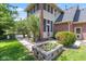 Landscaped backyard with manicured gardens and stone planter boxes, surrounded by lush greenery at 4465 W Woodbridge Ln, New Palestine, IN 46163